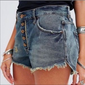 Free People button fly distressed jean shorts.